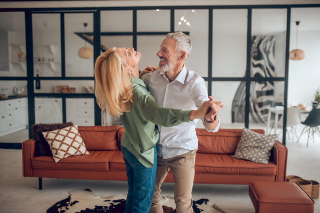 Dancing.,nice,couple,dancing,in,the,room,and,looking,happy