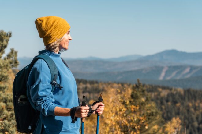 Woman,happy,to,hike,top,of,mountain,and,hold,trekking